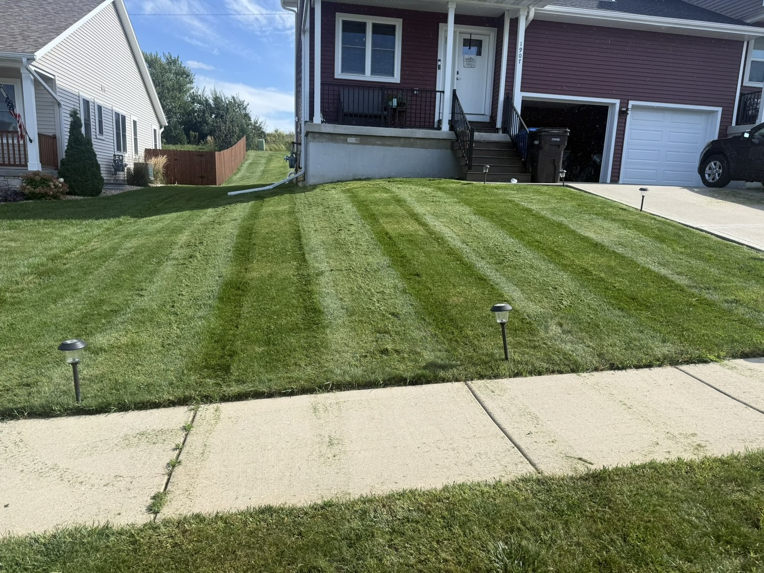 Diagonal stripes on a front yard along the sidewalk